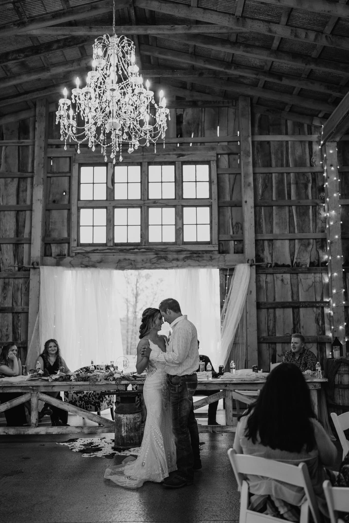 bride and groom's first dance under chandelier
